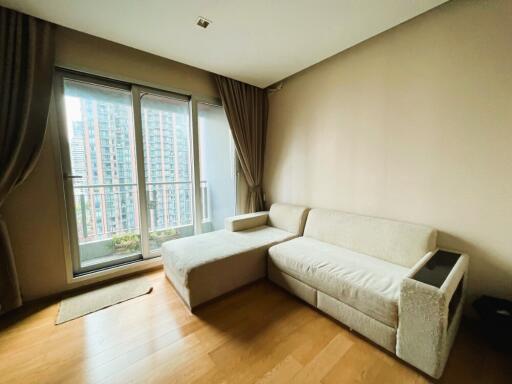 Living room with a sofa and large windows