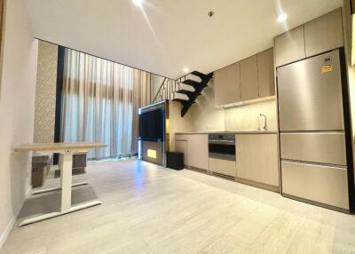 Modern kitchen and living area with stairs