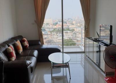 Modern living room with city view from large windows.