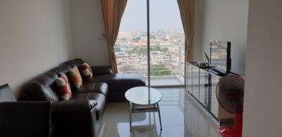 Modern living room with city view from large windows.