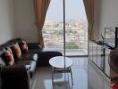 Modern living room with city view from large windows.