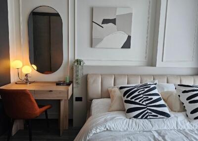 Modern bedroom with cozy decor and a workspace