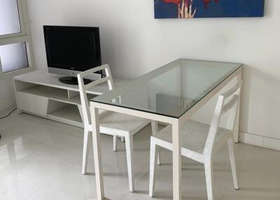 Living area with glass dining table and chairs