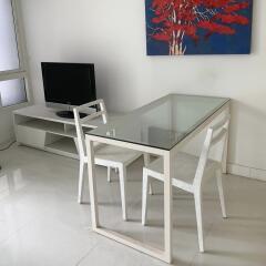 Living area with glass dining table and chairs