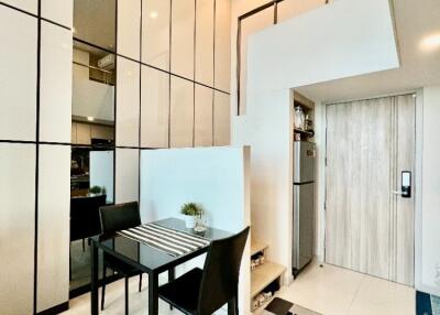 Modern dining area with high ceiling and integrated kitchen