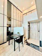 Modern dining area with high ceiling and integrated kitchen