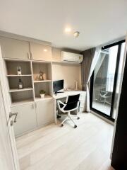 Modern bedroom with work station and large window