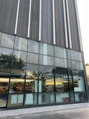 Modern commercial building with large glass windows and a storefront