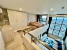 Loft bedroom with large windows and city view