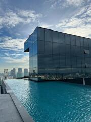 Modern building with rooftop infinity pool and cityscape view