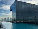 Modern building with rooftop infinity pool and cityscape view