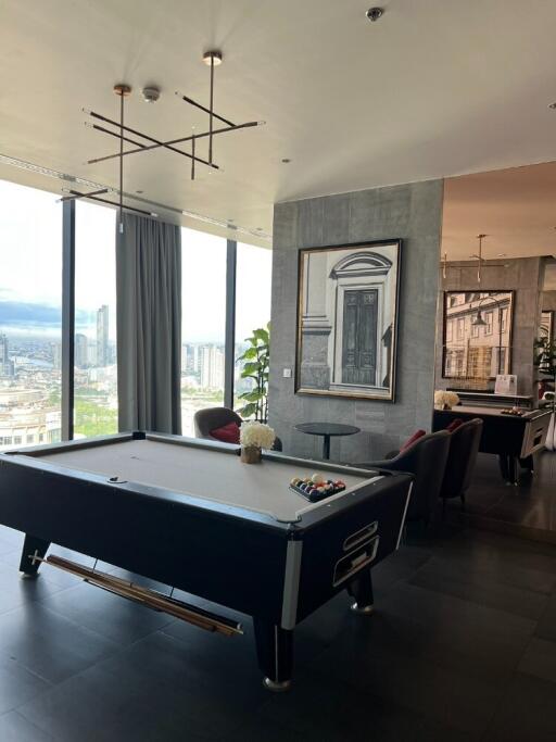 Modern living space with pool table and city view