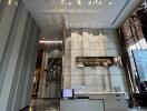 Modern reception area with check-in desk, illuminated ceiling decor, and Knightsbridge nameplate