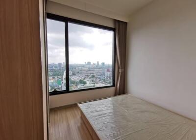 Bedroom with large window and city view