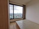 Bedroom with large window and city view