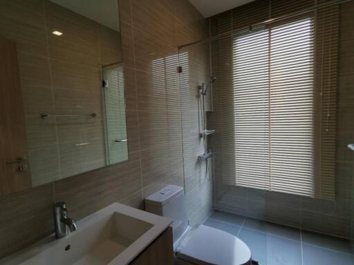 Modern bathroom with glass shower and window blinds