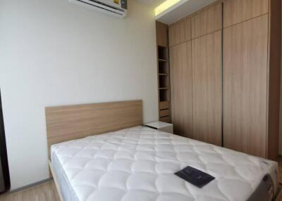 Modern bedroom with built-in wardrobe and air conditioning