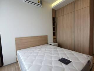 Modern bedroom with built-in wardrobe and air conditioning