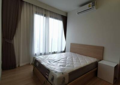 Bedroom with large windows and air conditioning