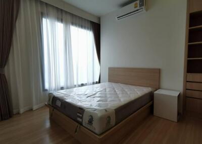 Bedroom with large window and air conditioning