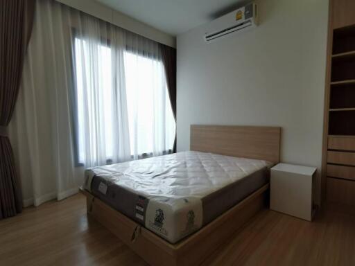 Bedroom with large window and air conditioning