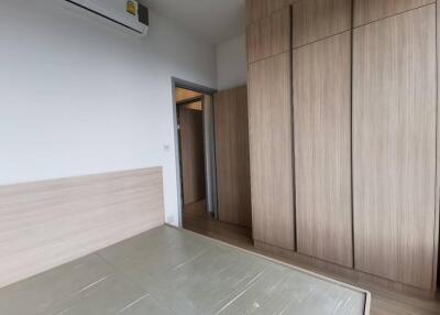 Modern bedroom with wooden wardrobes and air conditioning