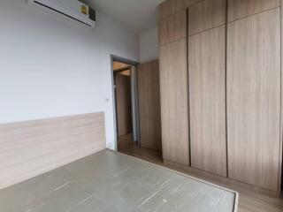 Modern bedroom with wooden wardrobes and air conditioning