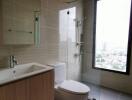 Modern bathroom with glass-enclosed shower and large window