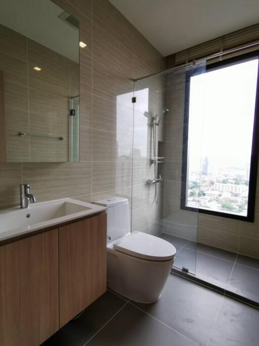 Modern bathroom with glass-enclosed shower and large window