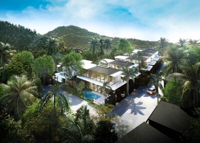 Aerial view of a modern residential complex surrounded by lush greenery