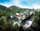 Aerial view of a modern residential complex surrounded by lush greenery