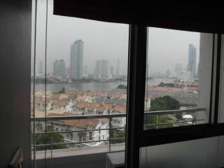 View from window showing cityscape and river