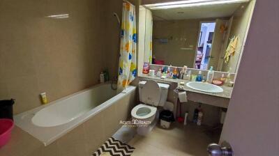 Bathroom with tub, toilet, sink, and large mirror