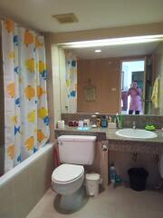 Bathroom with colorful fish-themed shower curtain