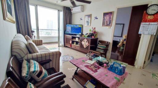 well-furnished living room with balcony access