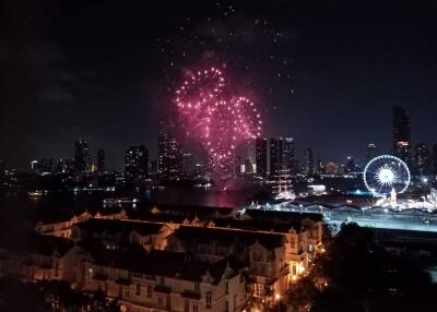 Night view of the city skyline with fireworks and a ferris wheel