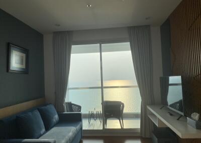 Living room with balcony view overlooking the ocean