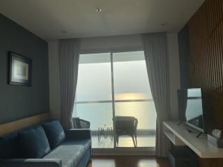 Living room with balcony view overlooking the ocean