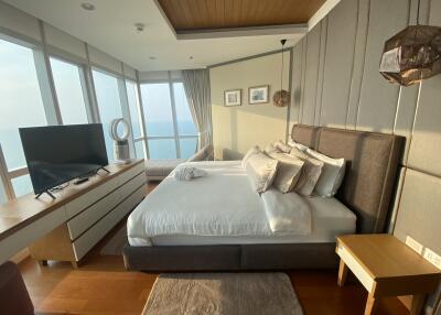 Spacious bedroom with large windows and ocean view