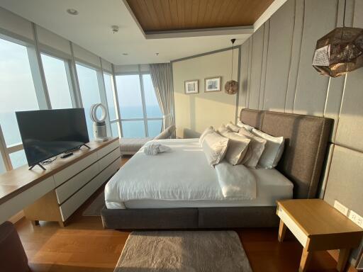 Spacious bedroom with large windows and ocean view