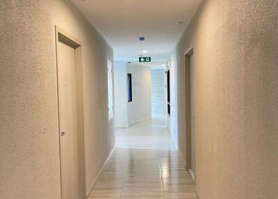 Hallway with tiled floor and recessed lighting