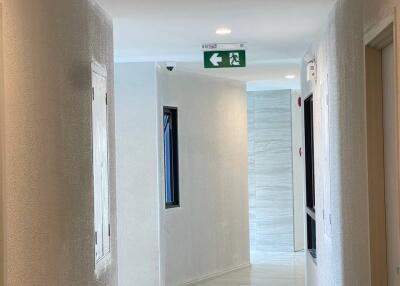 Corridor with emergency exit sign and doors