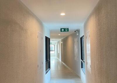 Hallway with light-colored walls and floors