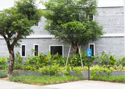 Front view of a building with natural landscaping