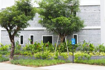 Front view of a building with natural landscaping