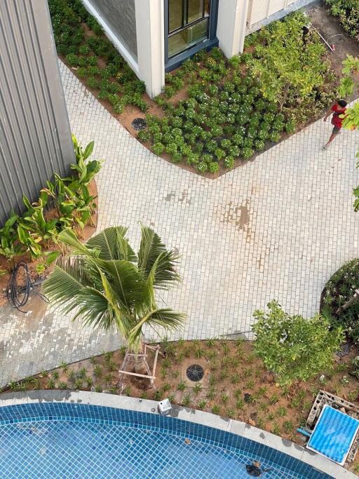 An aerial view of a building area with a pool