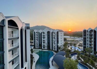 Modern residential complex with pool at sunset