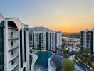 Modern residential complex with pool at sunset