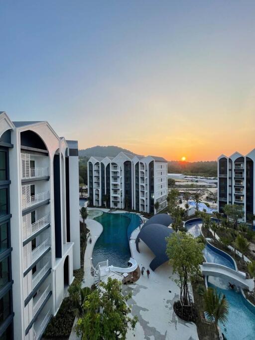 Modern residential complex with pool at sunset