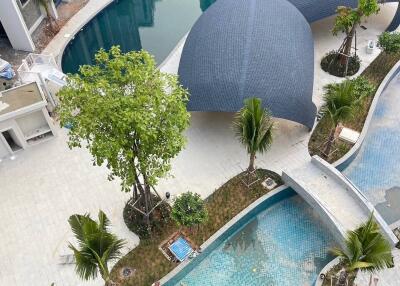 Aerial view of modern residential complex with pool and landscaped areas